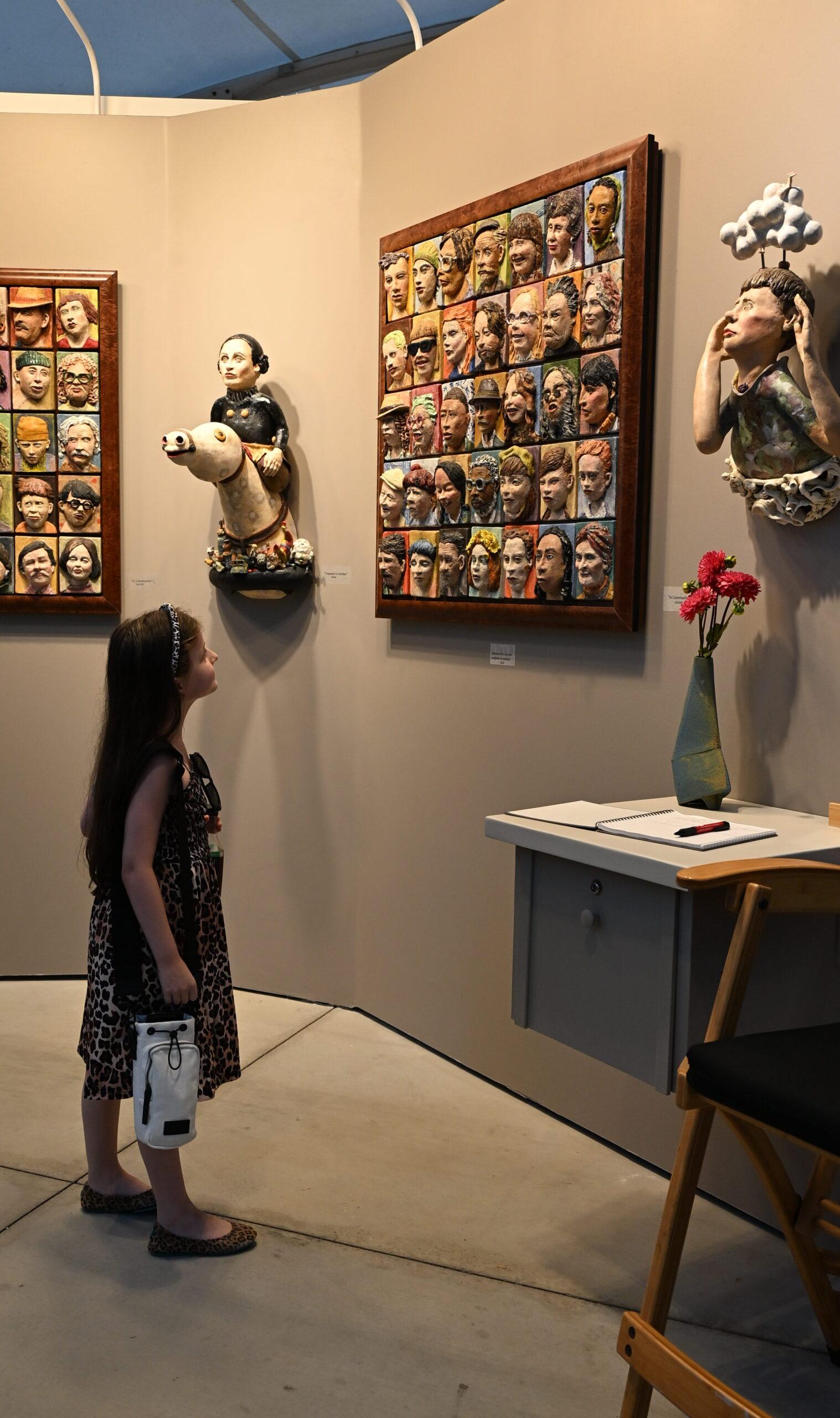 Livia looking at sculptures at Festival of Arts.  Image by Dan Sattel